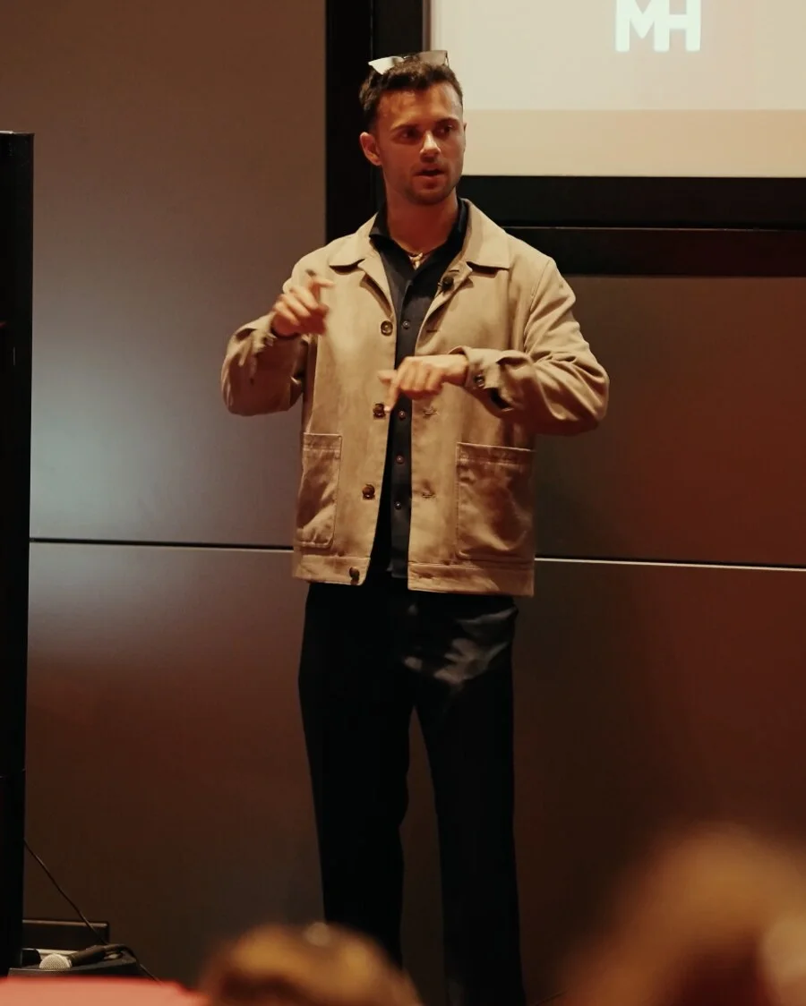 Ethan Monkhouse mid-talk on stage